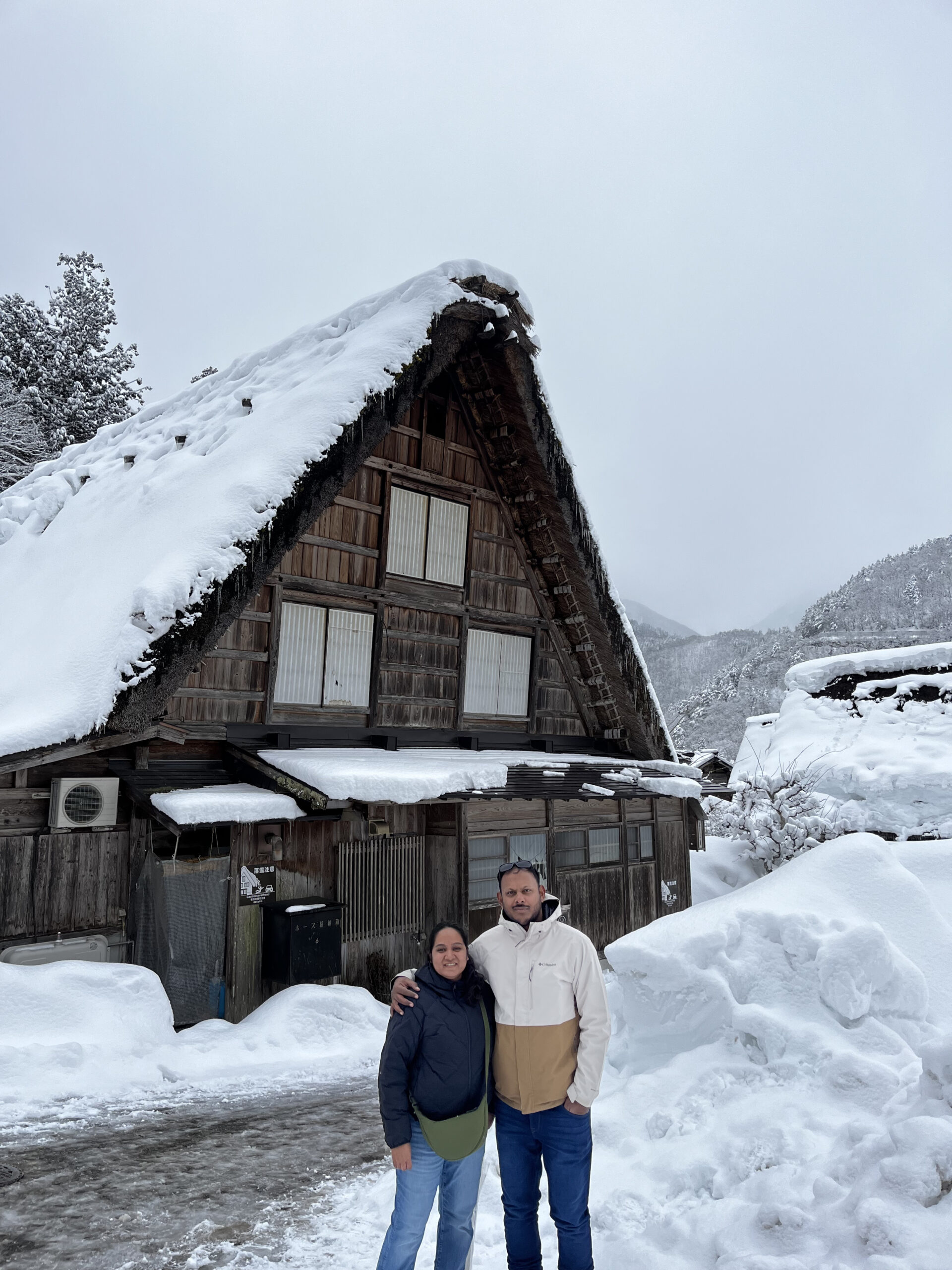 Gassho-zukuri farmhouse under deep snow in Shirakawa-go UNESCO village — day trip from Kanazawa
